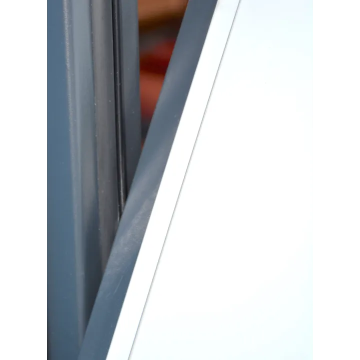 Lateral rubbing strip mounted on an up-and-over garage door