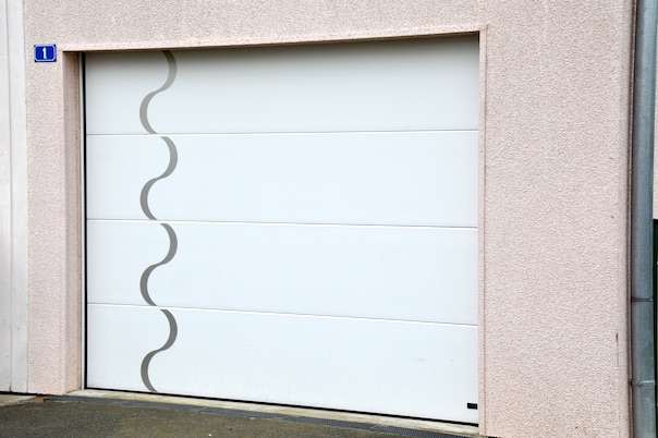 White sectional garage door with Wave S decorations