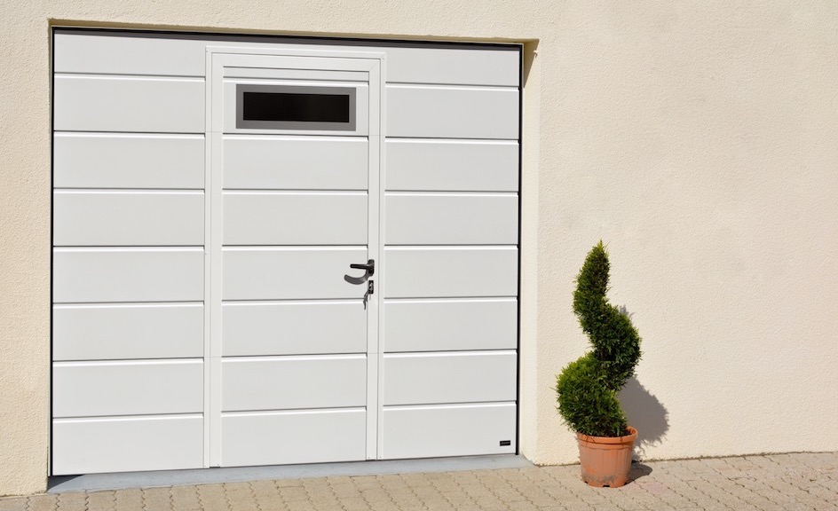 Sectional garage door with wicket door