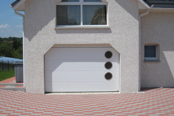 White sectional garage door with round portholes, smooth slats without groove