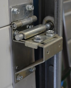 Garage door hinge with adjustable support